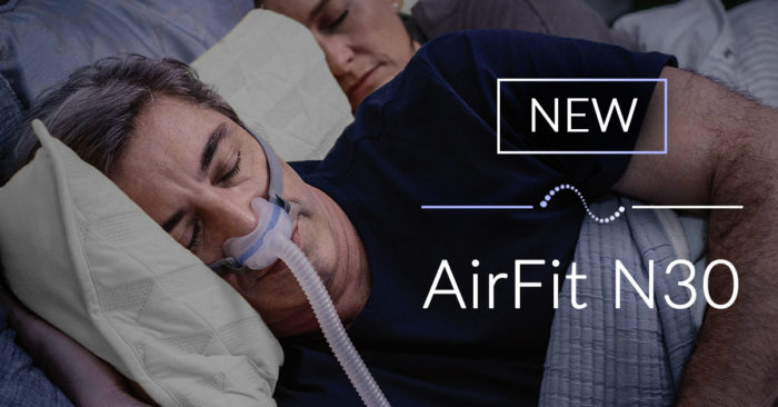 A man is using a ResMed AirFit N30 Nasal CPAP Mask (Fit Pack) for sleeping.