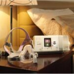 A discounted bed with a ResMed AirSense S10 Autoset for Her APAP Machine with HumidAir Humidifier cpap machine on top.