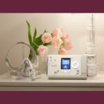 A discounted bedside table with a ResMed AirSense S10 Autoset for Her APAP Machine with HumidAir Humidifier and flowers.