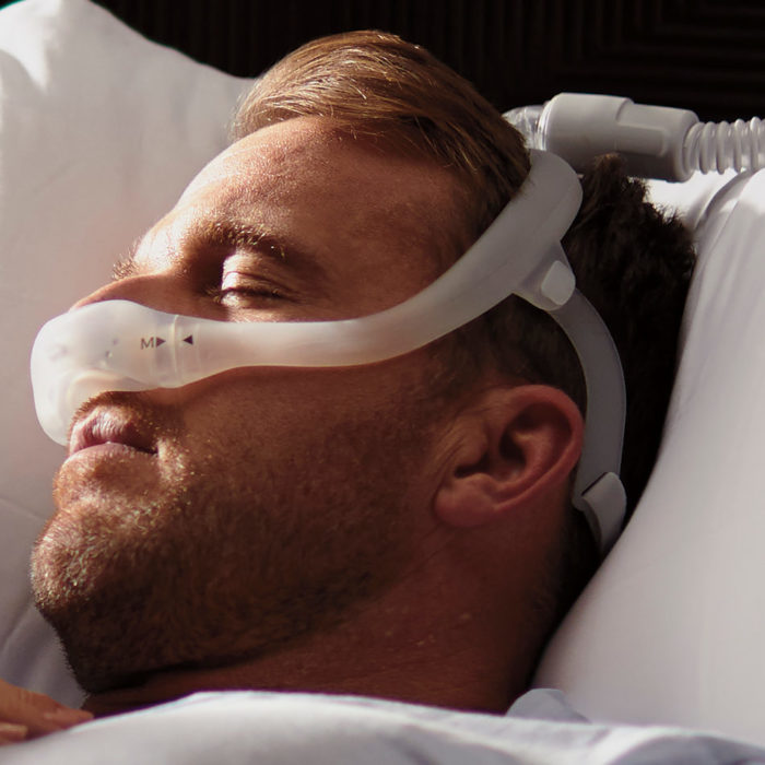 A man wearing a Respironics Dreamwear Nasal CPAP Mask Headgear with Arms.