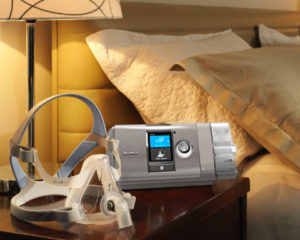 A discounted ResMed AirCurve S10 VAuto Bi-Level Machine Package with HumidAir Humidifier & Mask bed with a cpap machine.