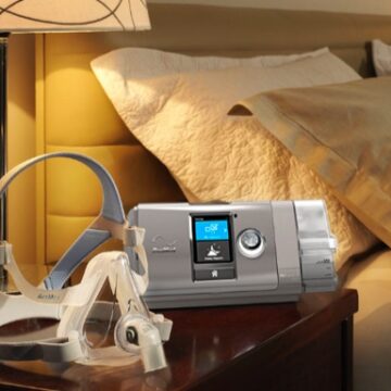 A discounted ResMed AirCurve S10 VAuto Bi-Level Machine Package with HumidAir Humidifier & Mask bed with a cpap machine.