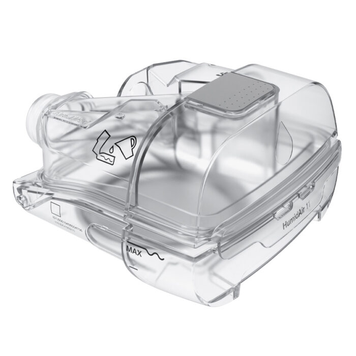 A clear plastic container with a ResMed AirSense 11 Autoset APAP Machine with HumidAir Humidifier and Heated Tubing on a white background.