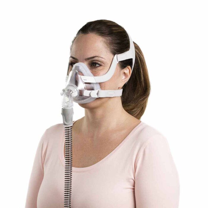 A woman wearing a ResMed AirTouch F20 Full Face CPAP Mask.