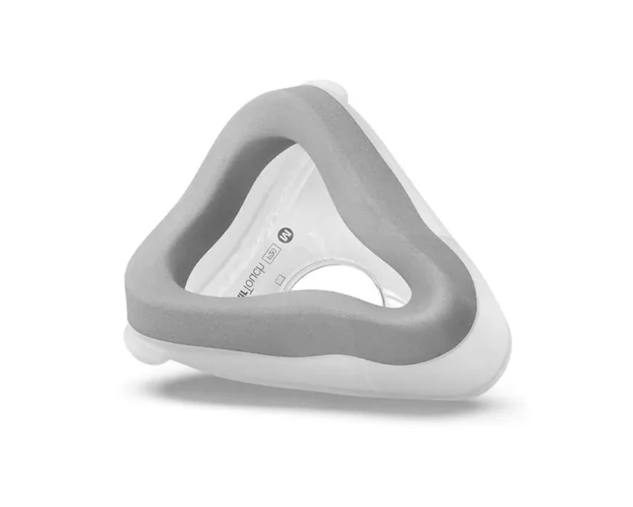 A white and gray ResMed AirTouch F20 Full Face CPAP Mask on a white surface.