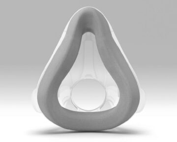 An image of a toilet seat and ResMed AirTouch F20 Full Face CPAP Mask.