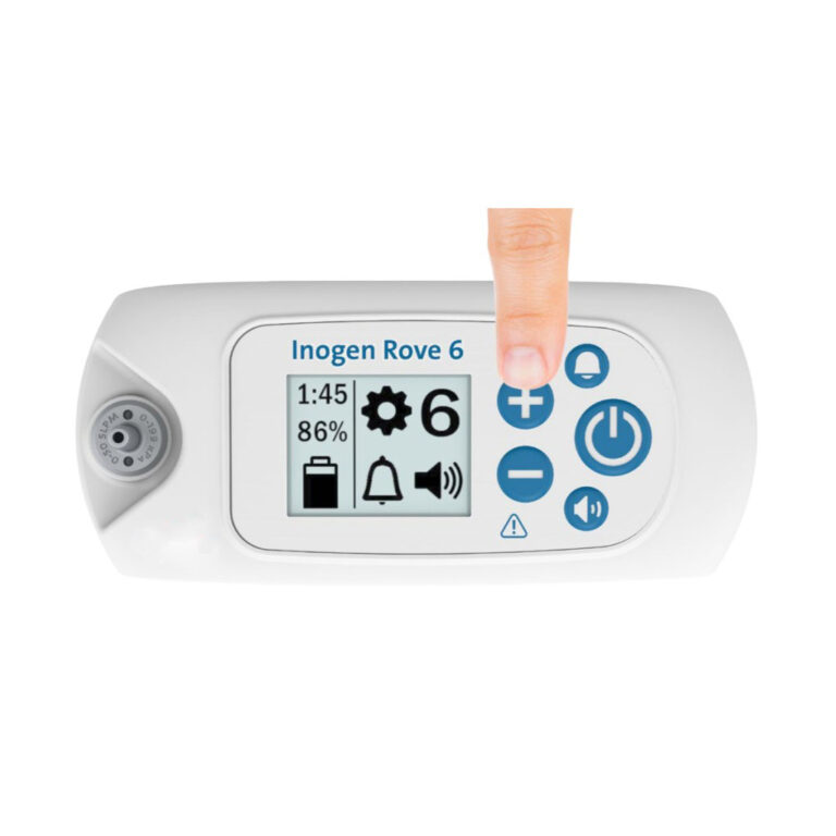 A hand is pointing at an Inogen Rove 6 Portable Oxygen Concentrator with 16 Cell Battery/Extended Life Battery.