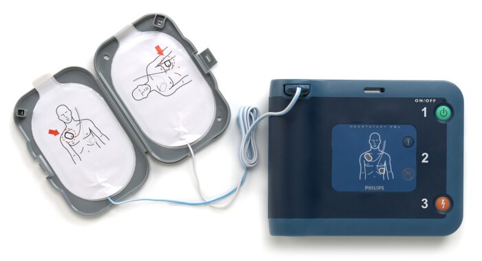 The Philips HeartStart FRx AED - a portable device equipped with a manual for immediate assistance - is the product.
