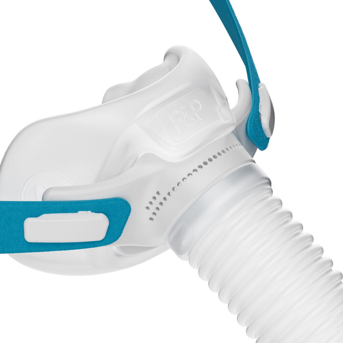 Close-up of a white and blue Fisher & Paykel Nova Micro Nasal Pillow CPAP Mask (Fit Pack) with flexible tubing and adjustable straps, isolated on a white background.