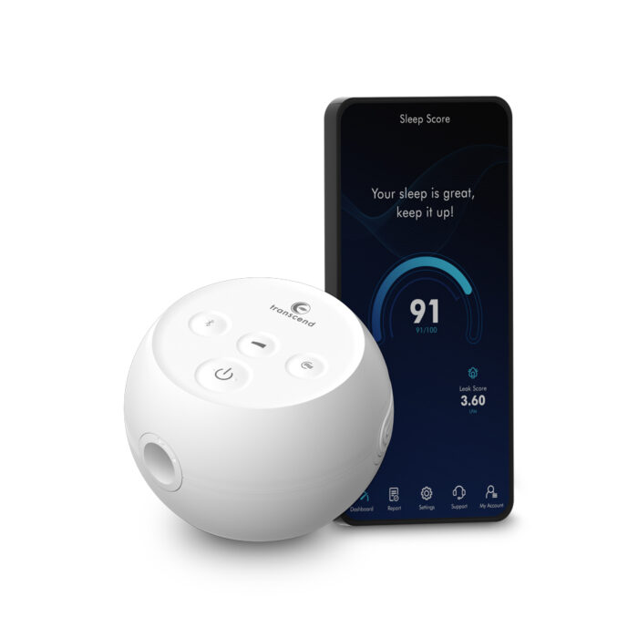 A white round sleep tracker device sits beside a smartphone displaying a sleep score on its screen, perfectly complementing your Transcend Micro Travel APAP Machine for a restful night's sleep.