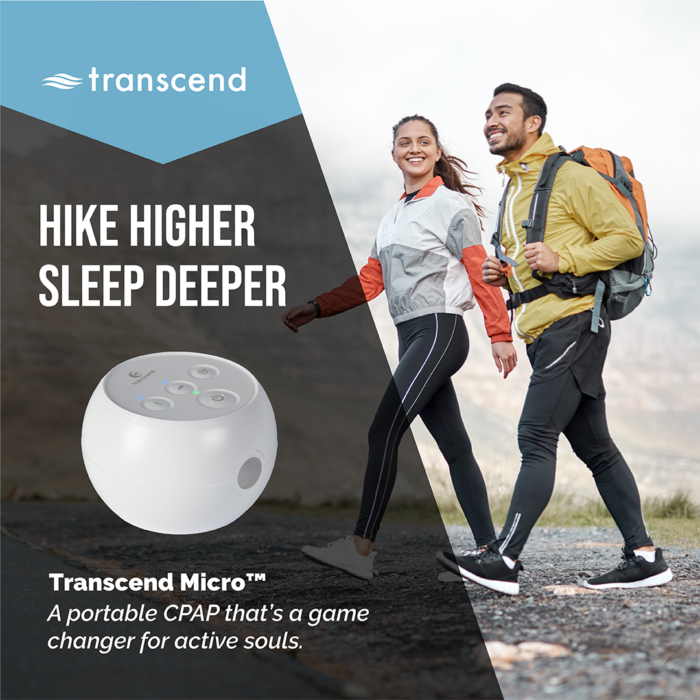 A man and woman hike on a mountain trail with a Transcend PowerAway Micro Battery portable CPAP machine equipped with the PowerAway feature. Text: "Hike Higher, Sleep Deeper.