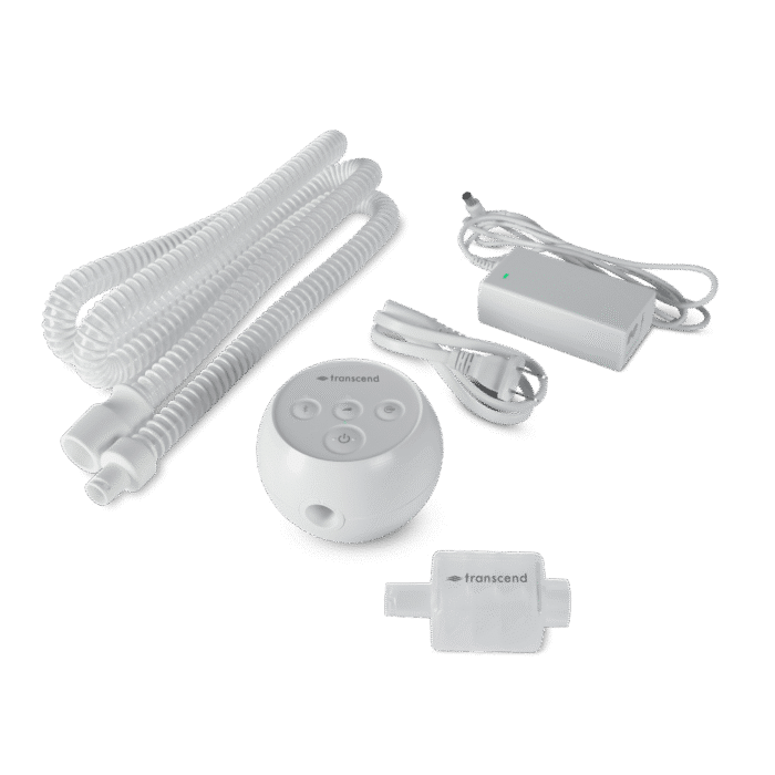 Transcend Micro Travel APAP Machine with accessories including a hose, mask, power adapter, and humidifier, all laid out on a black background. Perfect for Micro Travel with its compact design.