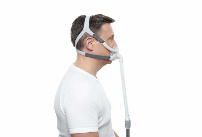 Side view of a person wearing a ResMed AirFit F40 Full Face CPAP Mask with headgear and hose attachment, against a white background.