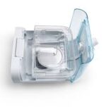 Respironics DreamStation Heated Humidifier with Chamber, featuring a clear plastic chamber and open lid, designed for DreamStation or compatible CPAP devices, is shown on a white background.