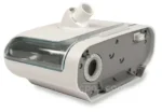 The Respironics DreamStation Heated Humidifier with Chamber features a white design, clear water tank, and hose connection, shown on a plain background.