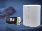 A woman sleeps with a CPAP mask, while the CSpring MK3 Automatic CPAP Water Chamber Replenishing System is shown in the foreground.