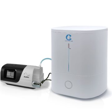 The CSpring MK3 Automatic CPAP Water Chamber Replenishing System connects to a white CPAP water chamber humidifier with a display screen and tubing.