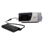 A ResMed CPAP machine powered by the Medistrom Pilot Flex CPAP Battery (Charcoal Black).