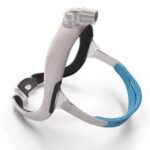 A ResMed AirTouch N30i Nasal CPAP Mask (Fit Pack) with headgear in white and blue, designed for sleep apnea therapy, is displayed on a white surface. Fit Pack offers customizable comfort and optimal fit.