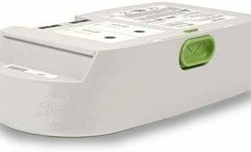 The SimplyGo Mini Extended Battery Kit is a rectangular electronic device with a green handle and various labels on its surface, designed for longer use.