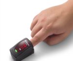 A hand uses the Nonin Onyx Vantage 9590 Finger Pulse Oximeter to display oxygen saturation and pulse rate.