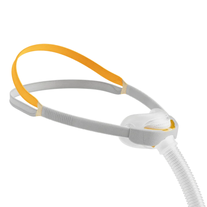 The Fisher & Paykel Solo Nasal CPAP Mask (Fit Pack) includes a comfortable grey and yellow head strap, white nasal cushion, and hose connection, providing stability and comfort for restful sleep.