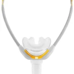 Close-up of a Fisher & Paykel Solo Nasal Pillow CPAP Mask (Fit Pack) in white and yellow, featuring headgear and a short hose attachment.