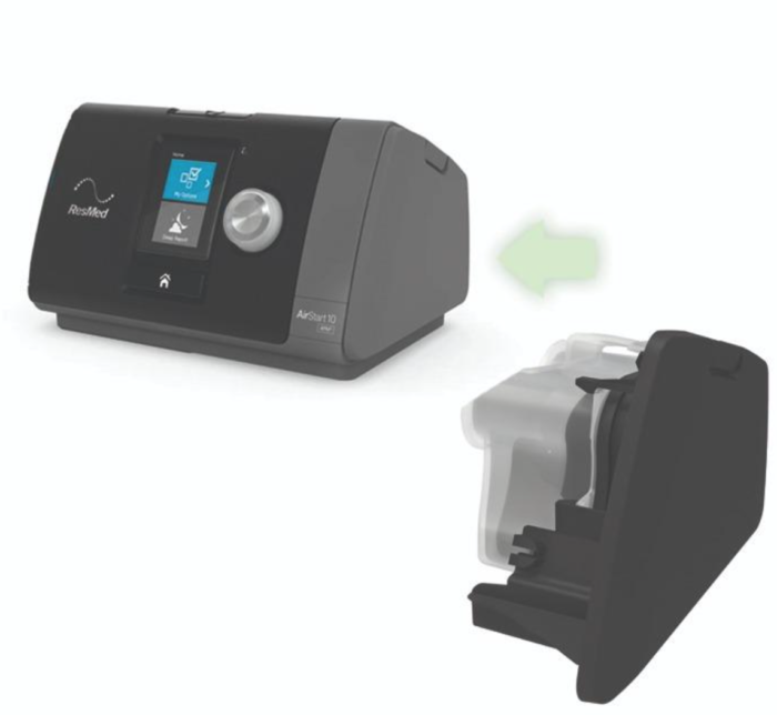 A CPAP machine with an arrow pointing to its removable water chamber component.