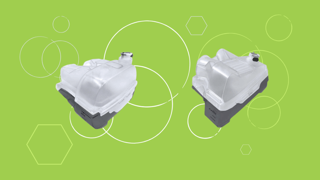 Two transparent water tanks with gray bases, designed for the CSpring MK3 CPAP water chamber, are set against a green background with white circles and hexagons.