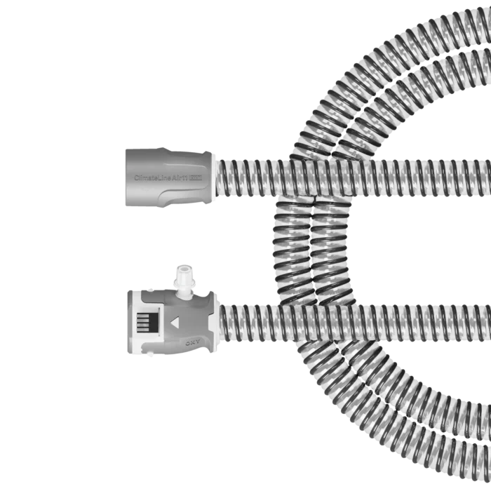 The ResMed ClimateLineAir 11 Oxy Heated Tubing is a gray and white flexible hose with connectors on both ends, arranged in a circular shape, compatible with ClimateLineAir 11 for heated tubing comfort.