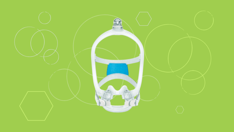 White ResMed AirFit X30i Full Face CPAP Mask with blue padding, displayed on a green background featuring circles and hexagons.
