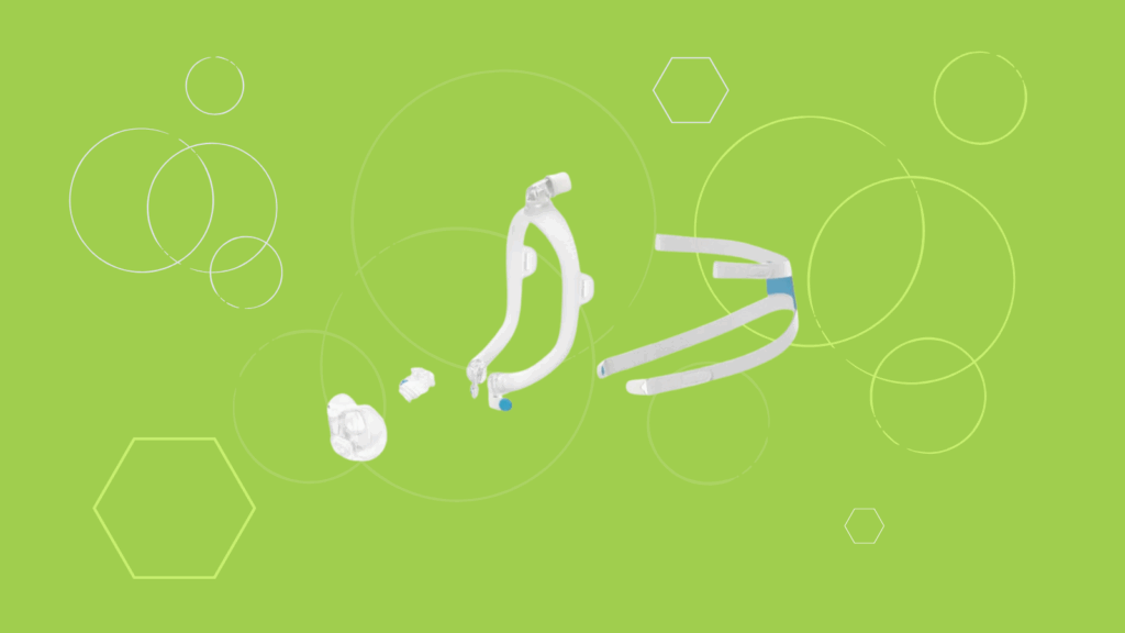 Two nasal CPAP masks, including the ResMed AirFit X30i, and a nasal cushion are displayed on a green background with hexagons and circles. Perfect for a quick product review or comparison with a Full Face CPAP Mask.