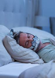 Person sleeping in bed wearing a ResMed AirTouch F30i Comfort Full Face CPAP Mask for sleep apnea therapy, experiencing comfort all night.