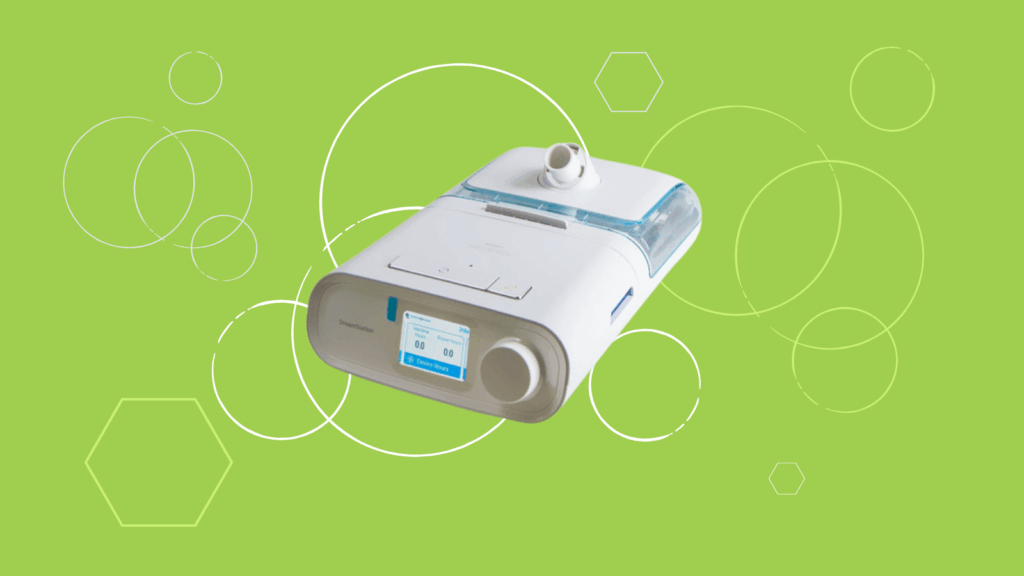 A Philips Respironics DreamStation CPAP machine with a humidifier is displayed on a green background with white geometric shapes.