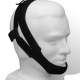 A mannequin head is shown wearing the Respironics Premium Chin Strap in black, a device commonly used to relieve sleep apnea or snoring.
