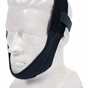 The Respironics Premium Chin Strap is shown on a white mannequin head, securing the chin and sides of the face.