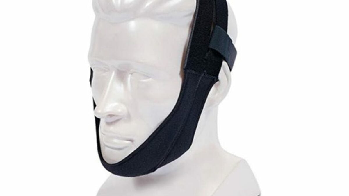 The Respironics Premium Chin Strap is shown on a white mannequin head, securing the chin and sides of the face.